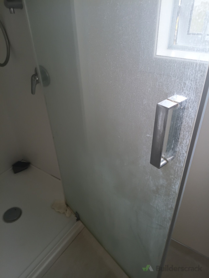 Build up on shower glass door - deep clean - before photo