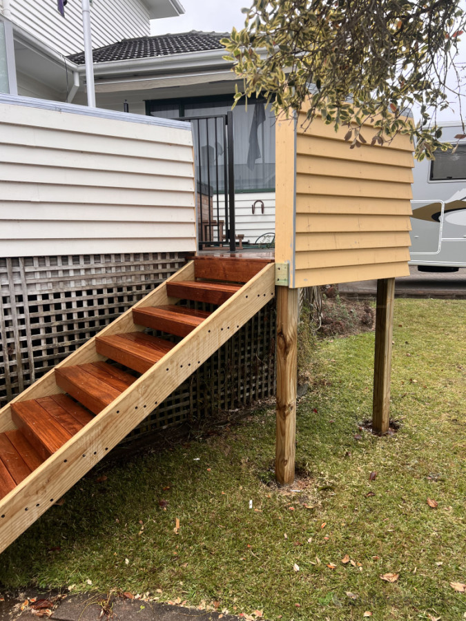 Added steps and landing to create front access to this deck. Was later painted to match and glass handrail installed