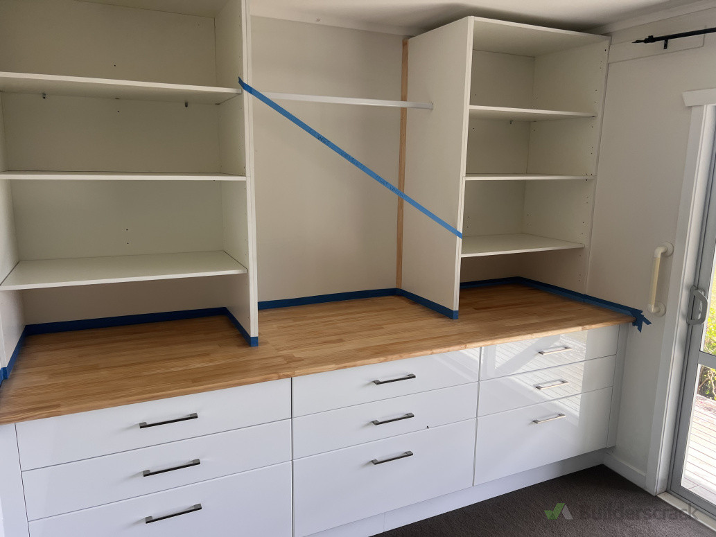 Custom full wall wardrobe and storage units. Later had sliding mirror doors installed from benchtop to ceiling.