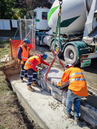 Placement of the capping blocks to the flood wall