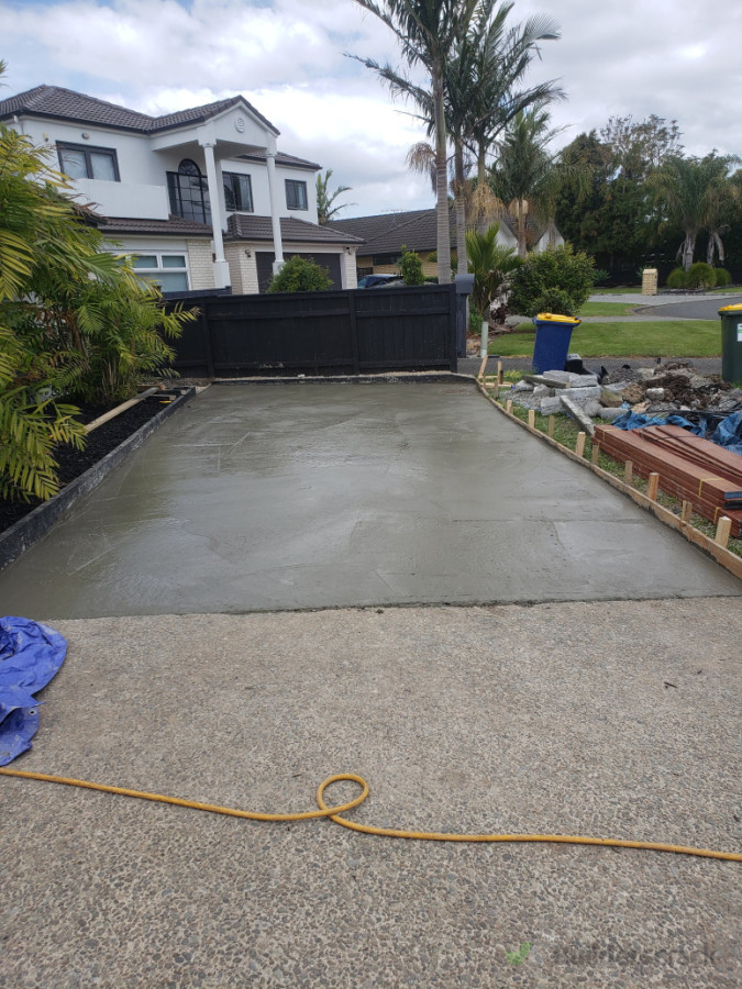 Exposed pebble concrete pour to extend driveway parking area