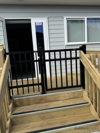 After: Front stairway secured with a newly installed gate for improved safety and access control.