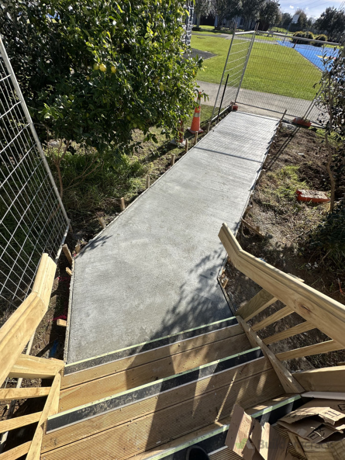 After: Newly poured concrete footpath with a durable broom finish for safety and traction. Control joints were cut shortly after