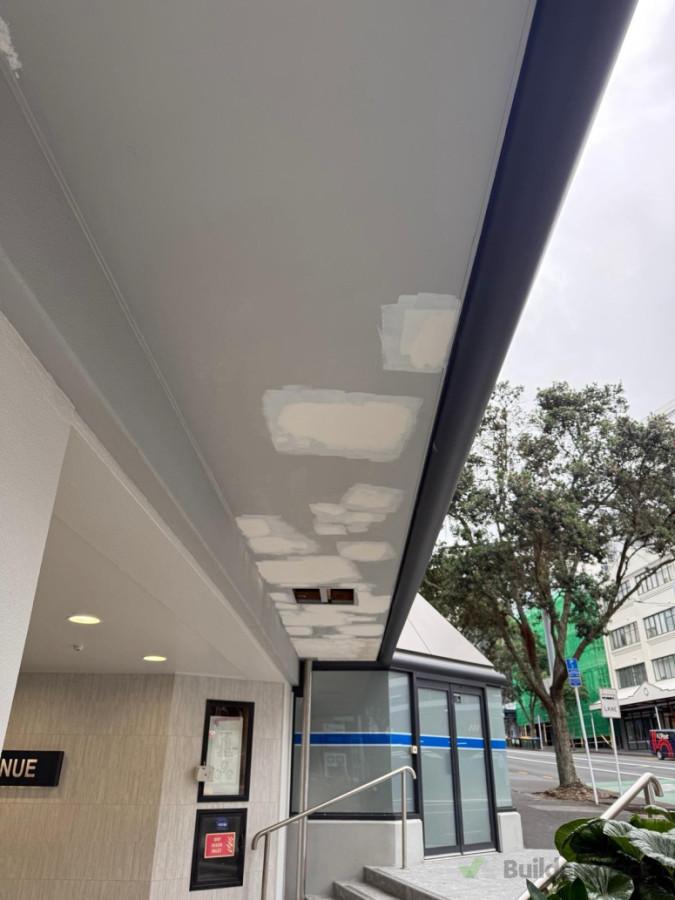 Exterior repair work in progress. skim-coating and patching  damaged sections to ensure the surface is perfectly smooth and ready for paint