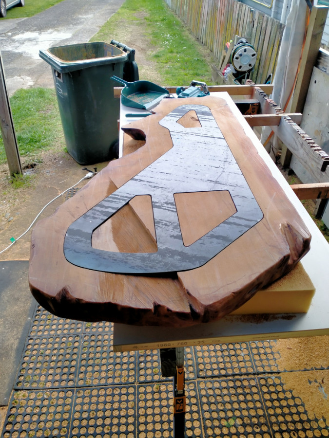 designed and steel laser cut to cantilever the slab over the base