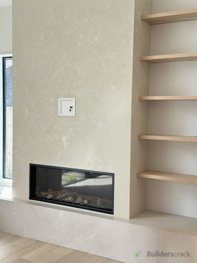 Interior residential feature wall painting completed around the fireplace area, with careful preparation and a clean, high-quality finish to create a defined focal point.