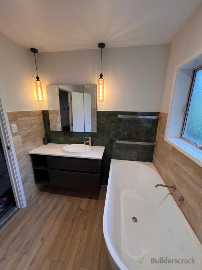 Bathroom upgrade with feature pendants, warm towel rails, and clean extraction.