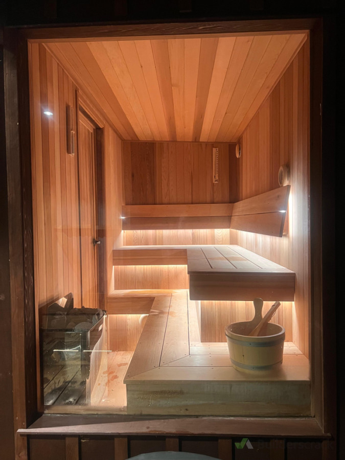 Sauna & wellness install — 8kW heater, subtle under-seat LED strip lighting, and ice bath setup.