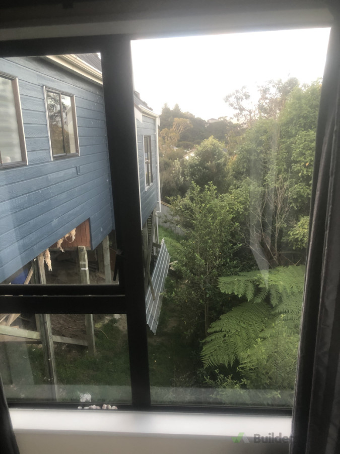 Existing master bedroom window looking out at proposed deck area.