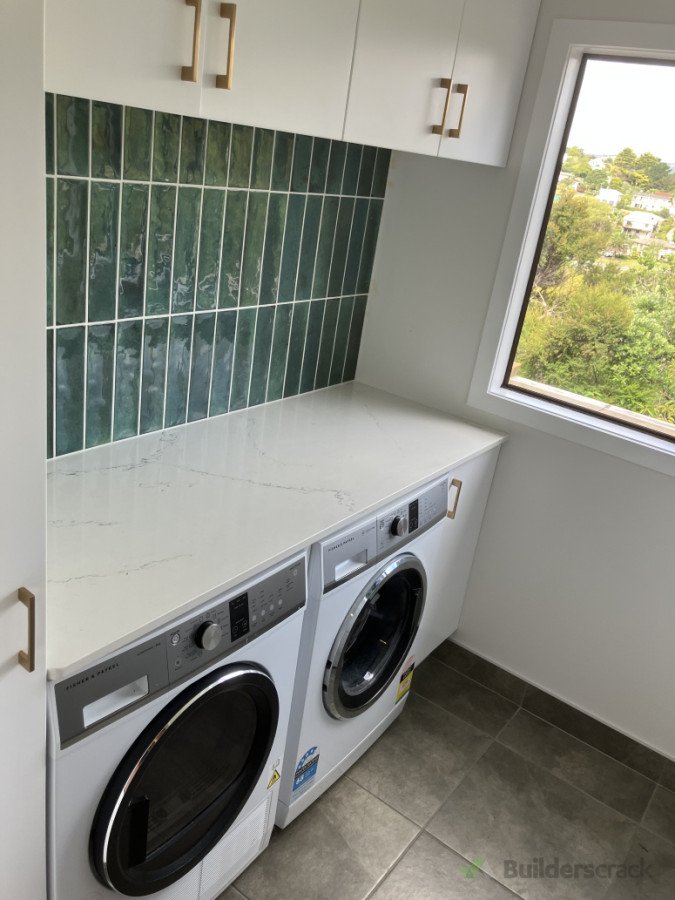 Tiled floor and splash back with stone bench top.