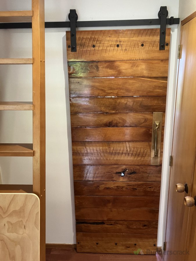 This door we made is recycled Rimu roof sarking. What better use then to turn it in to a barn style door.