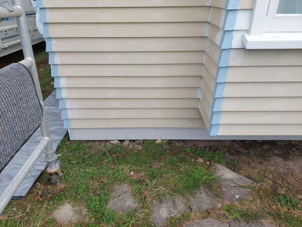 Weatherboards and soakers with base linings installed on new extension. .