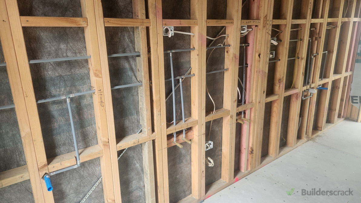 Bathroom plumbing rough-in – water and waste lines installed and pressure tested prior to lining.