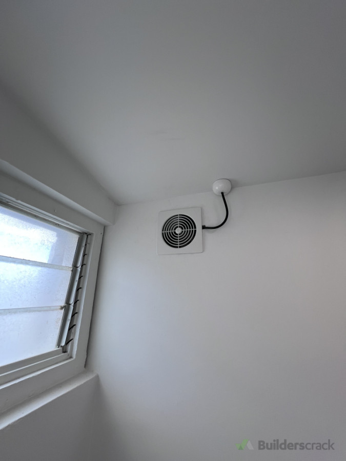 Installation of bathroom extraction fan with ducted venting to support effective airflow and moisture control in enclosed spaces.