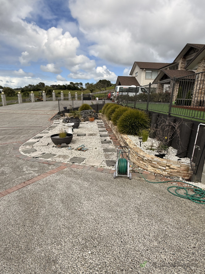 Stone planter box, water feature and exposed aggregate driveway