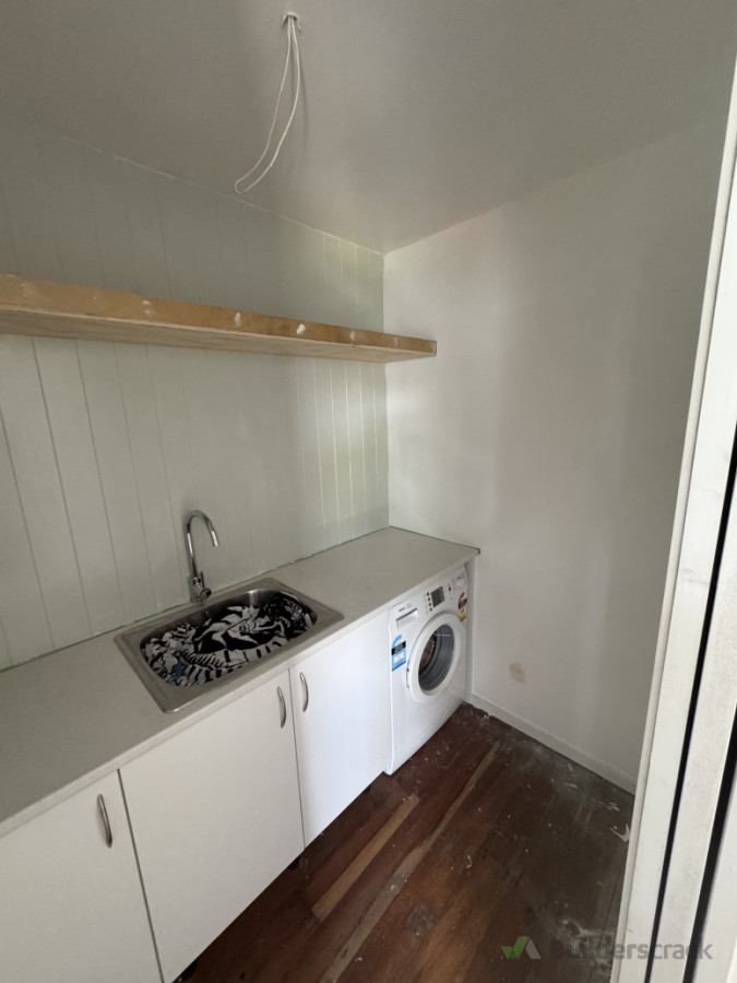 Laundry gutted and installed cabinetry, sink, feature wall