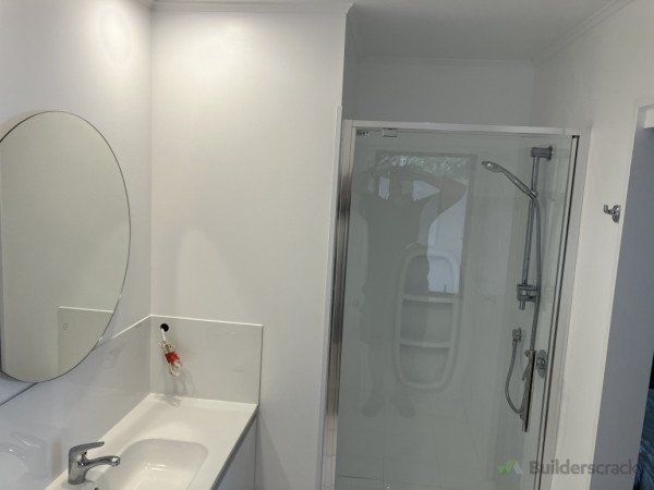 New shower enclosure installed with vanity and splash back