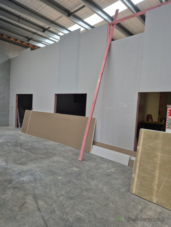 Wall lining installation for warehouse office conversion project.