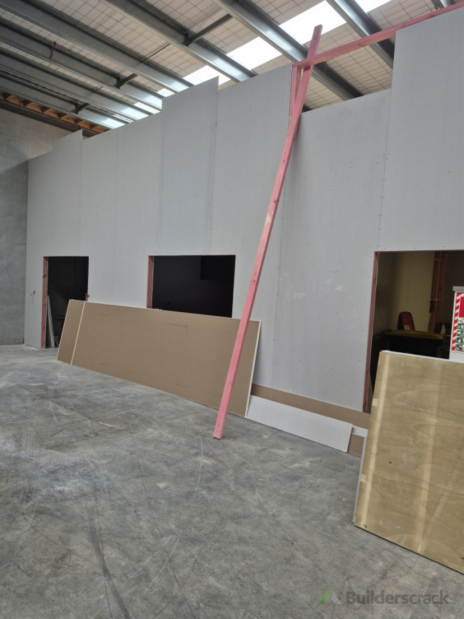 Wall lining installation for warehouse office conversion project.