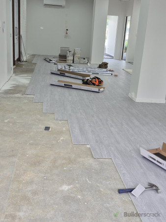 Vinyl plank flooring installation across the main hall area.