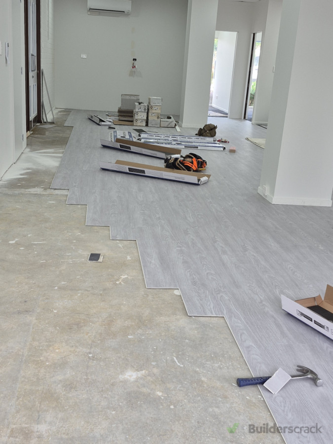 Vinyl plank flooring installation across the main hall area.
