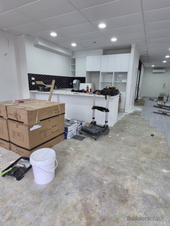 Kitchen area fit-out and flooring preparation during renovation.