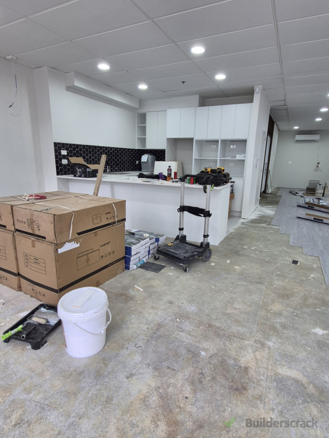 Kitchen area fit-out and flooring preparation during renovation.