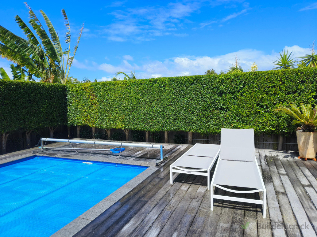 Garden maintenance and hedge trimming around pool.