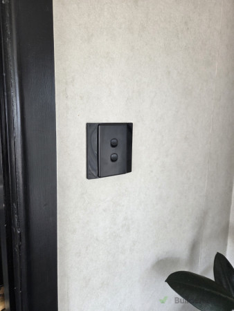 Replaced faulty light switch with new black one to suit decor