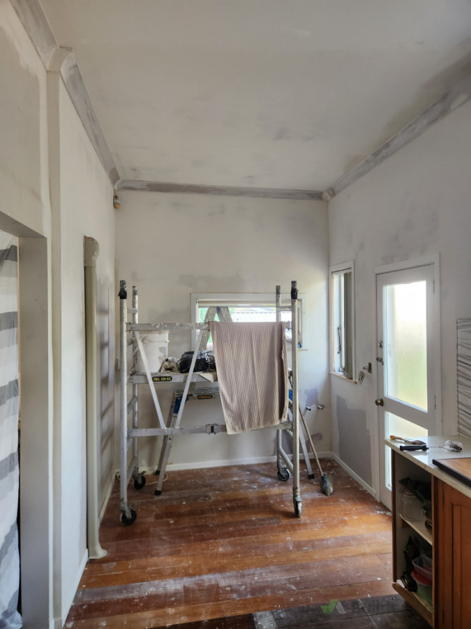 After photo of laundry ceiling matched in with kitchen height and existing wall removed.Beam professionally installed in roof space.