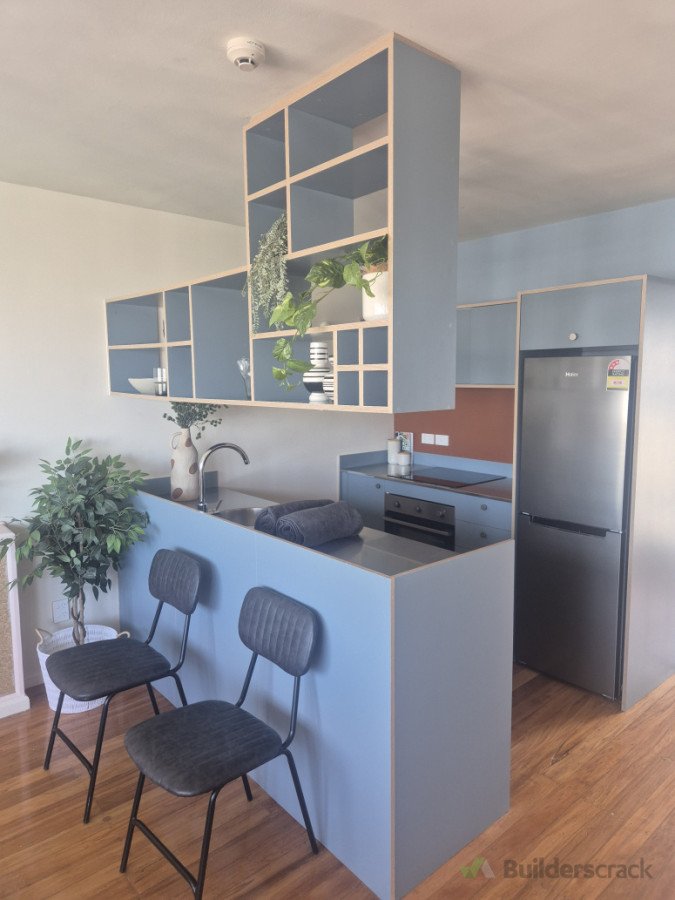Kitchen with ceiling mounted overhead cabinet