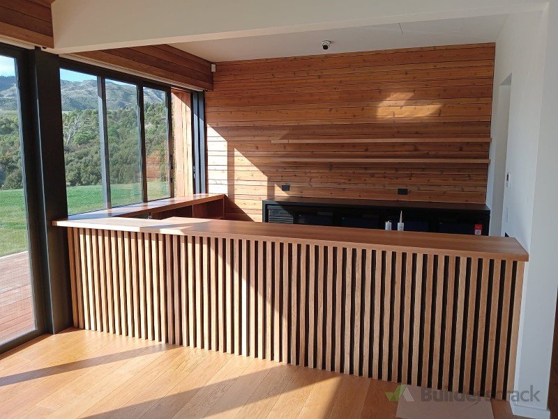 Bar with solid timber top and slats. Solid timber floating shelves