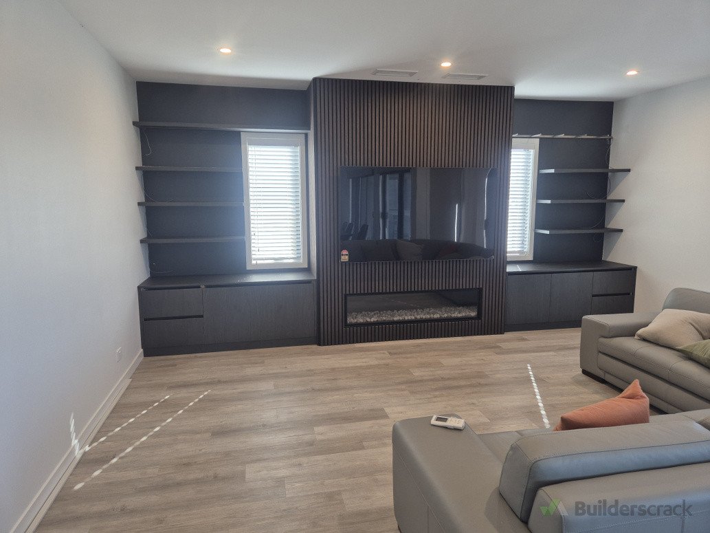 Panelling installed around fireplace with joinery either side