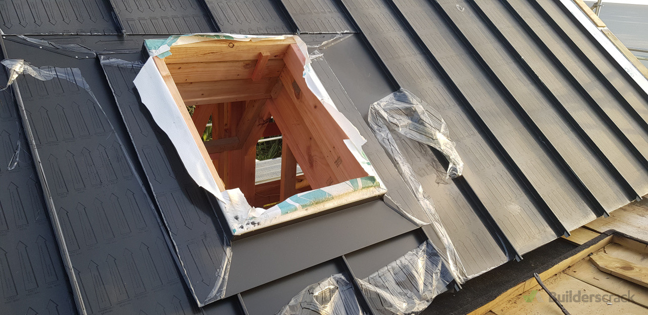 Skylight flashing installation completed with clean lines and precise detailing for a seamless, watertight integration into the metal roof.