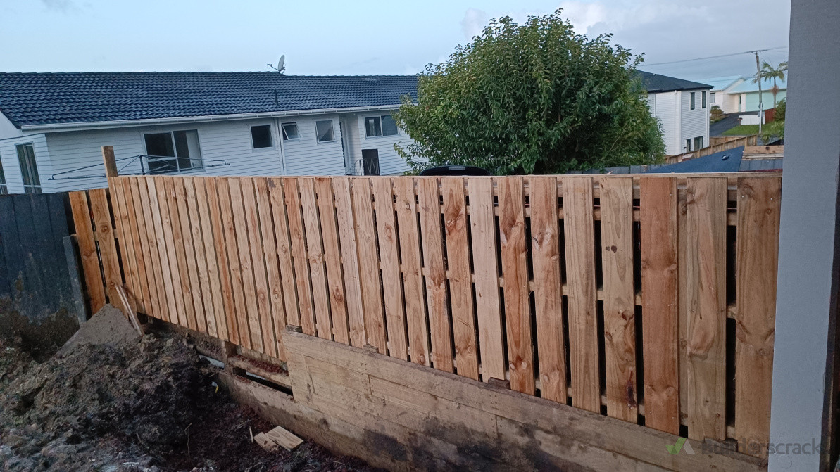 Construct a new retaining wall and Fence along the existing house