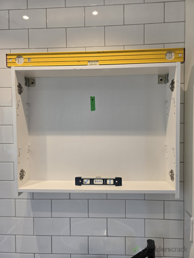 Fitting a bathroom cabinet onto a tiled wall