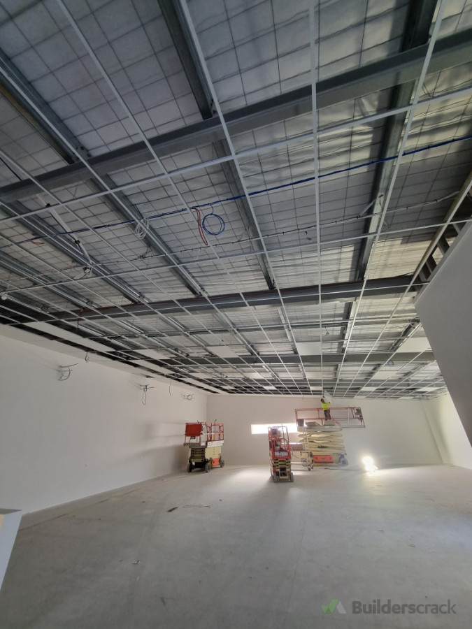 Grid and tile raking ceiling install for a timberyard office in Matamata, Aukland.
