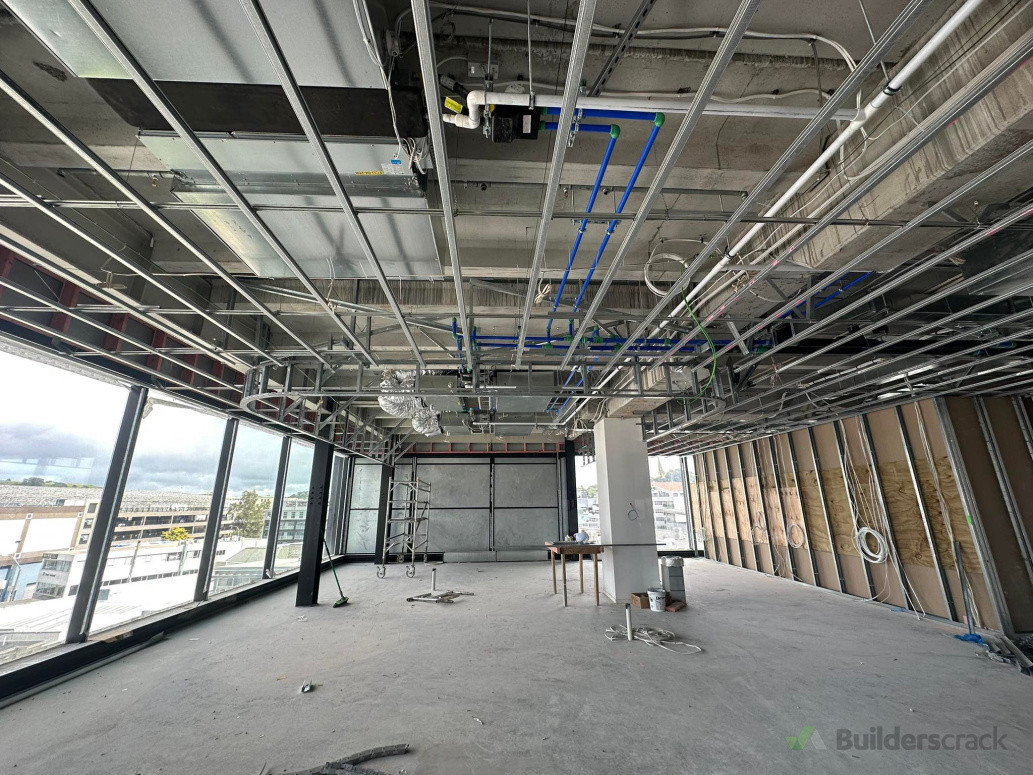 Suspended ceiling with a feature curved bulkhead for an apartment lounge in New Market, Auckland.