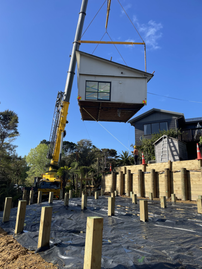 Building relocation onto piles, retaining walls