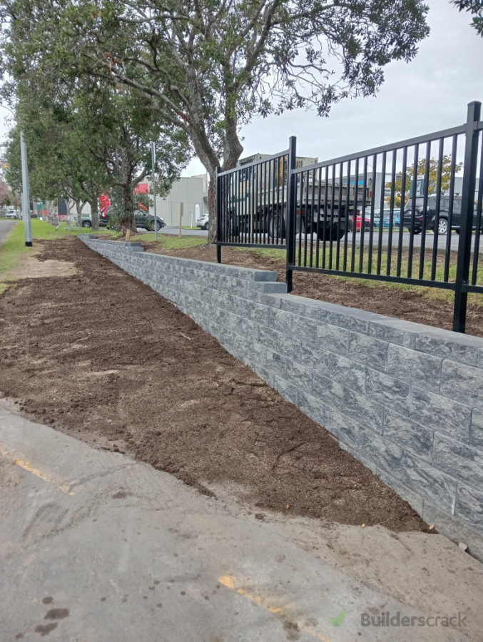 Keystone 3 and block retaining wall with aluminum fence on top.