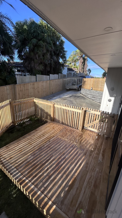 We cut back the deck to make an additional parking space and installed a fence around to keep her dog from getting out.