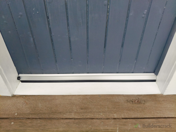 Completed door, repainted and with appropriate storm stopper added to keep rain and drafts out.