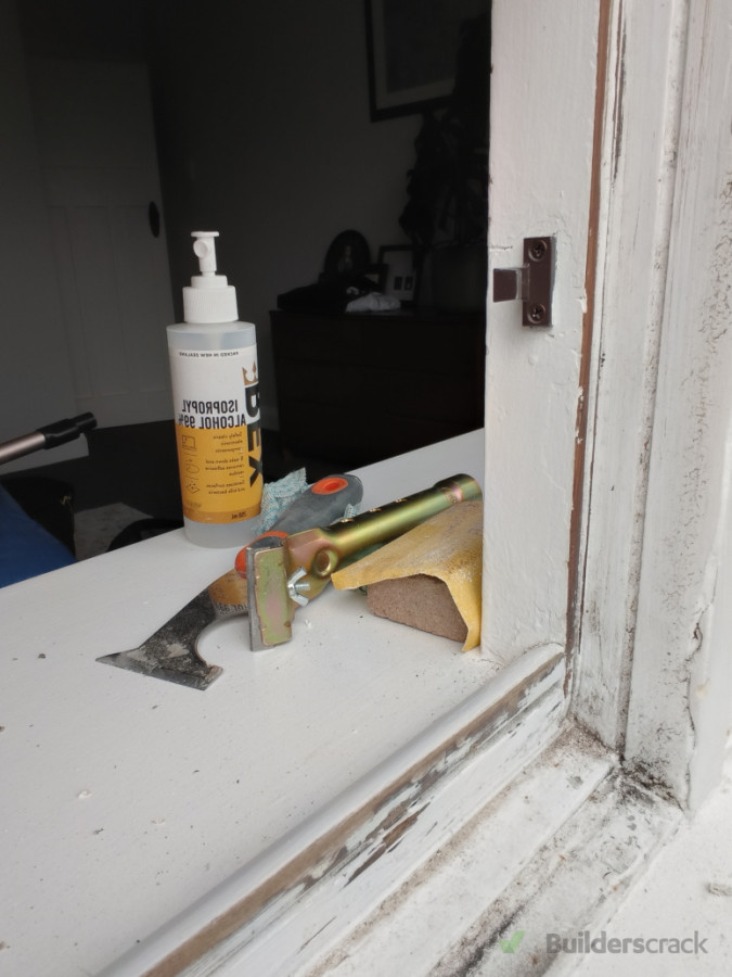 Sanding, repainting and cleaning various window frames to square them up and prepare them for the rubber draft seals.