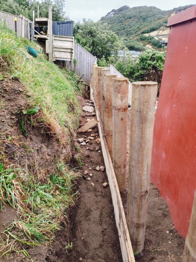 Boards going on, with trench behind for the drainage elements