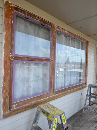 Old flaking/peeling paint stripped to the bear wood