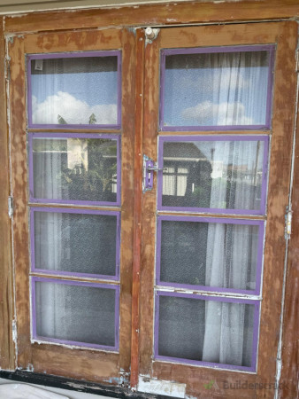 Old flaking/peeling paint stripped to the bear wood
