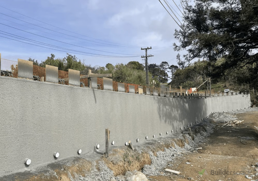 Concrete roadside retaining wall with shotcrete finish.