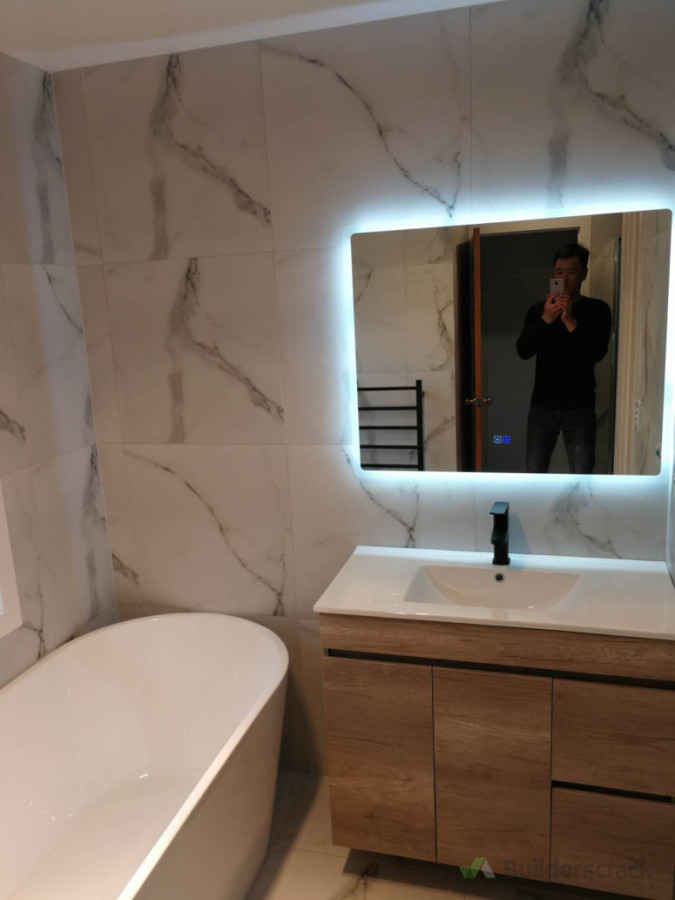 Fully demolished. New freestanding bath,led mirror and vanity. Also a tiled alcove shower on the other corner.