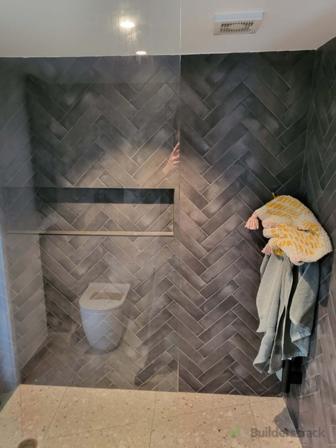 Fully demolished. Hard work for tiler with small tiles go cross. Curb Walk-in shower with single glass panel.