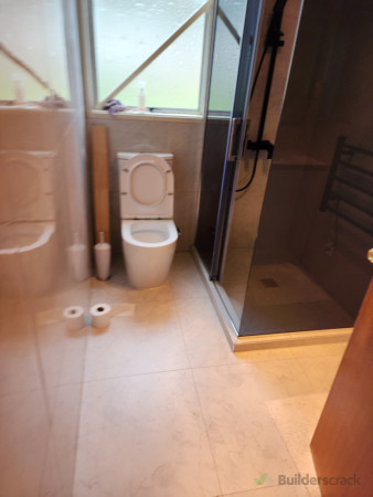 Water Closet and Shower setup with tile finish.